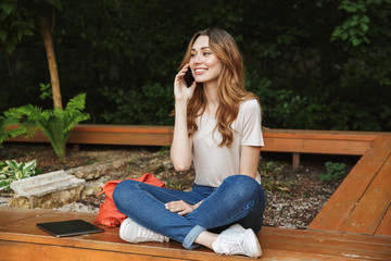 Canvas Print - Smiling young girl talking on mobile phone