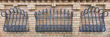 Iron Wrought-iron Lattice Adorns A Brick Fence