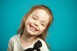 © Ilshat - Sweet little girl smiling on blue isolated background.