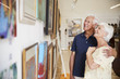 © Monkey Business - Senior Couple Looking At Paintings In Art Gallery