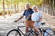 © Monkey Business - Portrait Of Smiling Senior Couple Cycling On Country Road