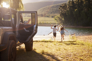 Family Reaching Destination By Lake After Road Trip