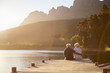 © Monkey Business - Romantic Senior Couple Sitting On Wooden Jetty By Lake