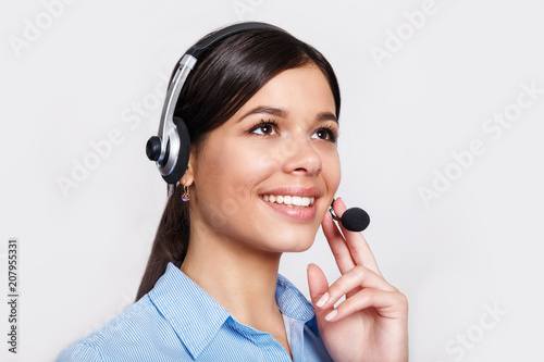 Fotografía customer support phone operator in headset, with blank copyspace area for slogan or text message, over grey background