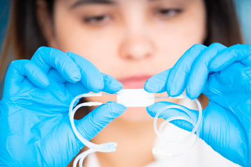 Sticker - technician girl with microfluidic device LOC in microbiological lab