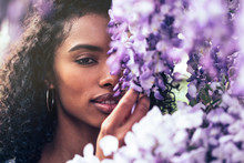 Young Black Woman Surrounded By Flowers