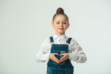 Wall Mural - beautiful little smiling girl on a light background