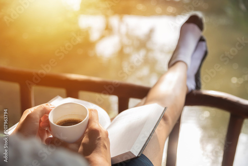 Fotografía Happy Woman sitting and holding cup of hot coffee.
