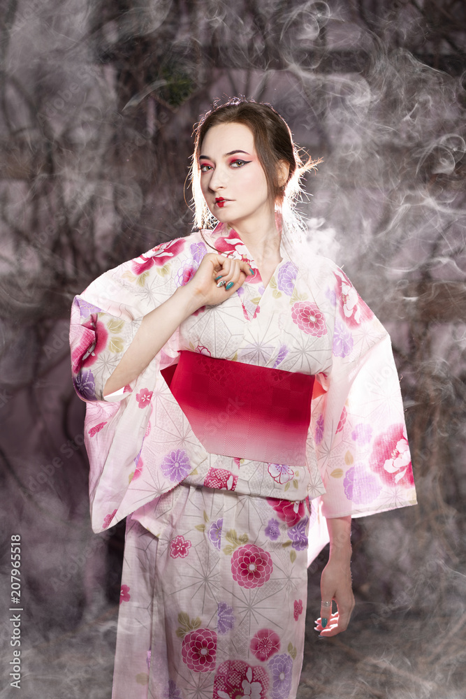 elegant girl in a classic traditional dress Japanese kimono white and pink  standing alone on dark background in the studio Stock Photo | Adobe Stock