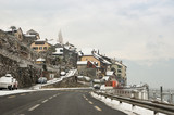 Fototapeta  - A village in the snow along the road.