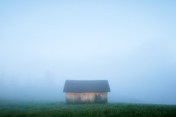 Wall Mural - mountain valley during sunrise. alone house on foggy meadow. located place: carpathians, ukraine, eu