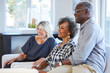 © Trinette Reed/Stocksy - Group of smiling multi-ethnic seniors listening to a talk/ lecture
