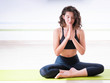 © kohanova1991 - Young beautiful woman with short curly hair meditating in light fitness studio. Hands in namaste. Pray, gratitude, yoga, love God concept.
