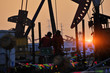 © qiujusong - Oil field oil workers at work