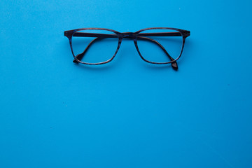 graduated glasses on blue background