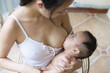 © Bonaoke/Stocksy - Young asian mother breastfeeding her baby boy in home