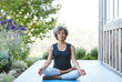 © Trinette Reed/Stocksy - African American Senior woman doing yoga at home