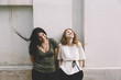 © AlexeyKuzma/Stocksy - happy real lesbian couple on the street
