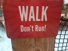 Red Walk Don't Run Sign Near Water