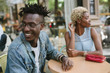 © Lauren Naefe/Stocksy - Young man on date at outdoor cafe in city