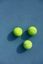 Three Tennis Balls On Court