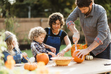 Family Carving Pumpkins Together