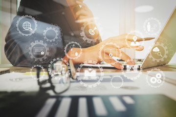 Poster - business documents on office table with laptop computer with smart phone and graph business diagram and man working in the background