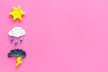Wall Mural - weather forecast concept. modern weather icons set on pink background top view copy space