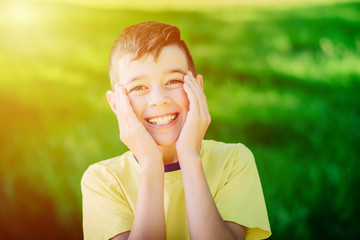 Wall Mural - portrait of laughing teenage boy in park