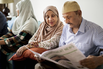 Wall Mural - Muslim family reading the news