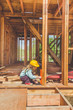 © dmitrypk - child in a helmet on the construction site of a wooden house