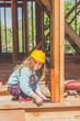 © dmitrypk - child in a helmet on the construction site of a wooden house