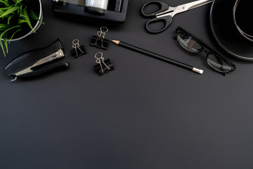 Poster - Flat lay of top view modern black desk work table with computer laptop and stationary in home office includes copyspace for add text or graphic