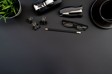 Poster - Flat lay of top view modern black desk work table with computer laptop and stationary in home office includes copyspace for add text or graphic