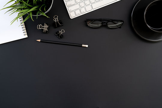 Flat lay of top view modern black desk work table with computer laptop and stationary in home office includes copyspace for add text or graphic