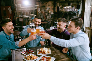 Men Drinking Beer In Pub