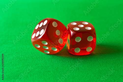 Foto Dice on a green background . Game concept. Games of chance