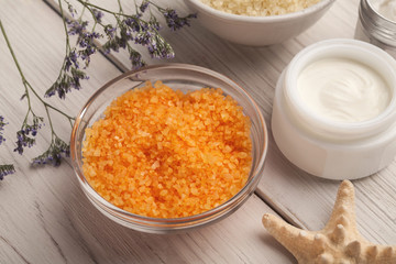 Wall Mural - orange sea salt and face cream on white wood