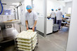 © Connect Images - Cheese maker packing cheeses to send off to suppliers