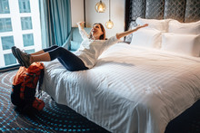 Woman Tourist Backpacker Happy To Stay In High Quality Hotel Room After Long Trip