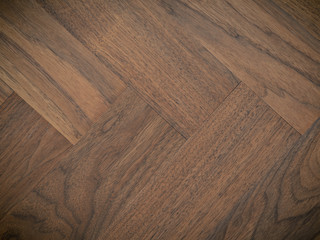 Old used herringbone walnut parquet