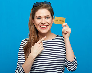 Casual dressed woman in striped shirt holding credit card and po