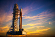 Space Launch System On Launchpad Over Background Of Red Clouds