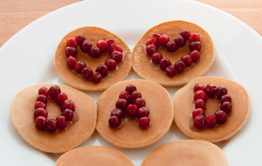 Wall Mural - Pancakes with maple syrup and cranberries on a white plate. Concept Father’s day. Greeting Card, Gift, Surprise. Two Hearts and text Dad. Idea Family Brunch, Breakfast. Snacks. Sweets. Food.