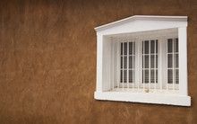 White Wooden Window On Adobe Building In Santa Fe, New Mexico