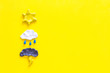 Weather forecast concept. Modern weather icons set on yellow background top view copy space