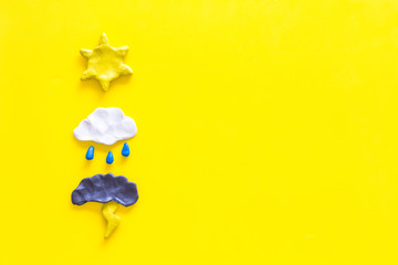Wall Mural - weather forecast concept. modern weather icons set on yellow background top view copy space