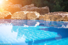 Outdoor Inground Residential Swimming Pool In Backyard With Hot Tub. Sun Flare