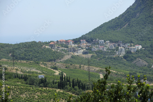 Fotografia, Obraz View of a small resort town Krasnokamenka situated at a foothill of a mountain, sea in the background