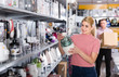 © JackF - Young female is choosing new blender for his kitchen in store